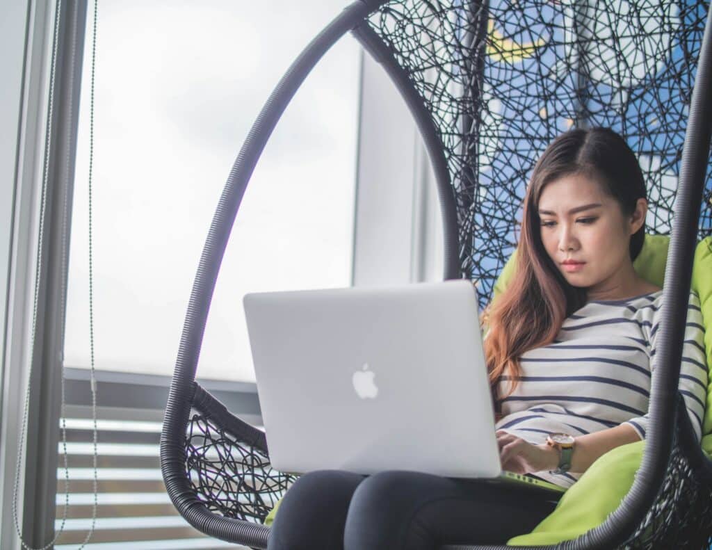 Woman working on her laptop outdoors.